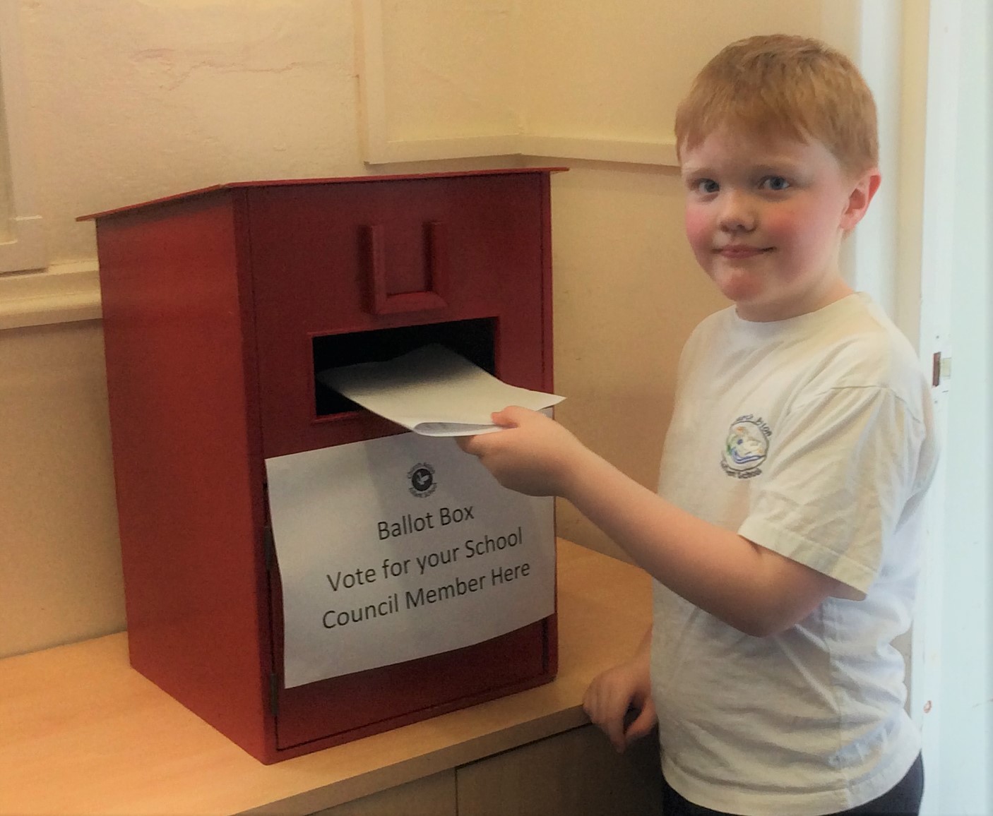 Children vote for their school council candidate.